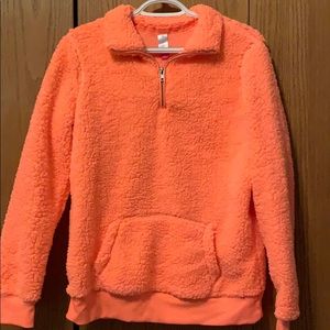 A coral quarter zip Sherpa with front pocket